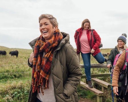 Mature women walking through a field on a winter day
