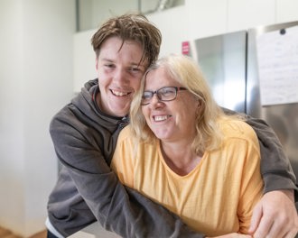 Man cuddling woman