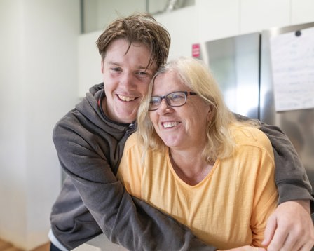 Man cuddling woman