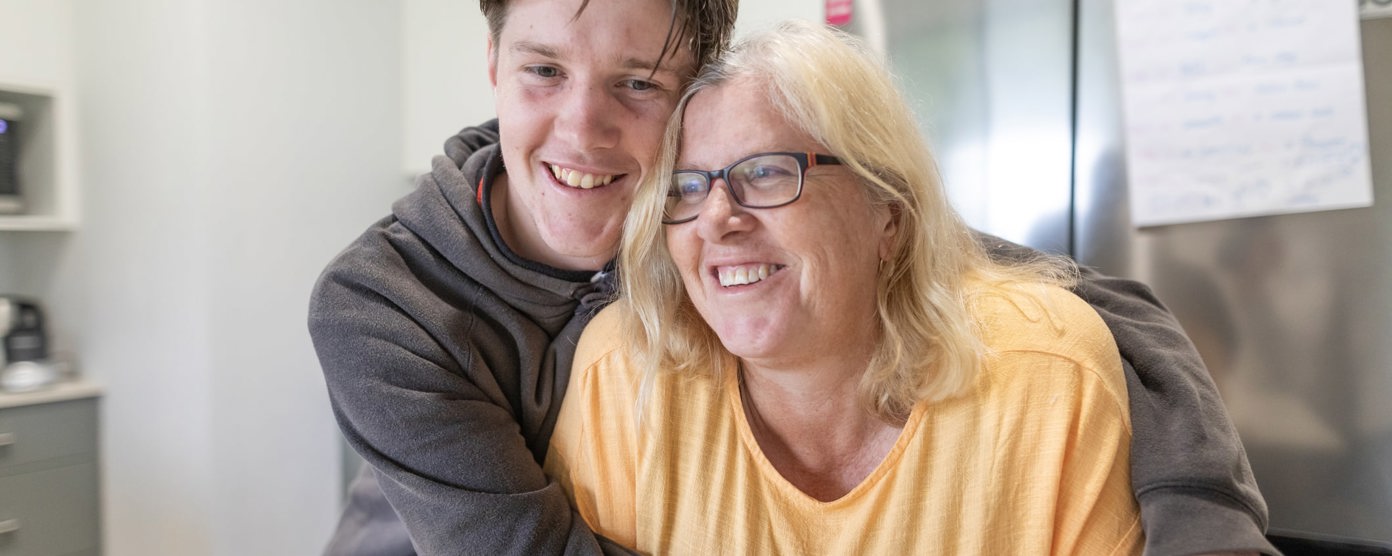 Man cuddling woman