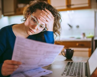 woman-looking-worried-at-kitchen-table