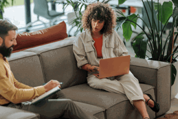Women sat on sofa with laptop