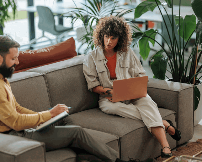 Women sat on sofa with laptop