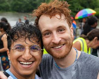Two people smiling in front of a crowd