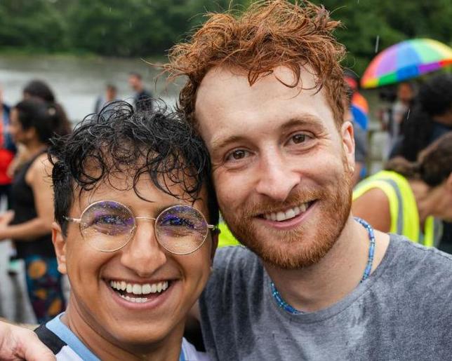 Two people smiling in front of a crowd